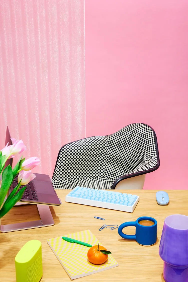 Pastel desk setup with keyboard and props, modern workspace lifestyle photography