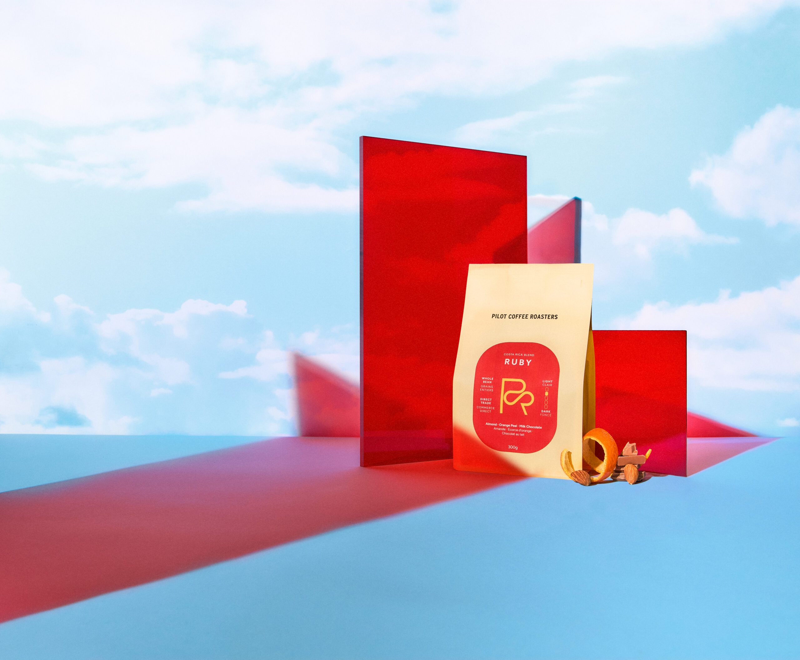 Coffee bag product shot with red acrylic panels and blue background, commercial still life photography