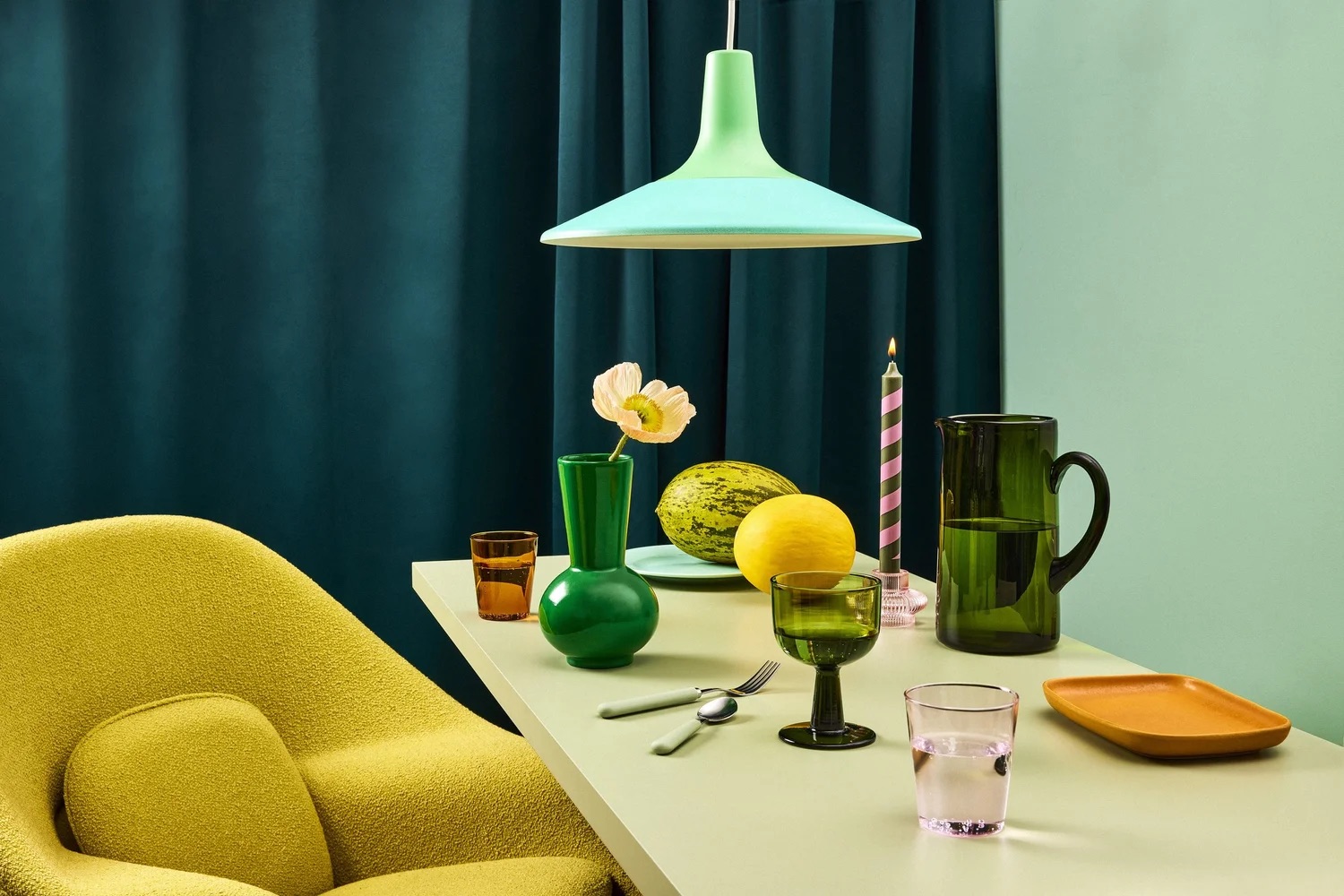 Green dining table still life with lemons and glassware, editorial lifestyle photography