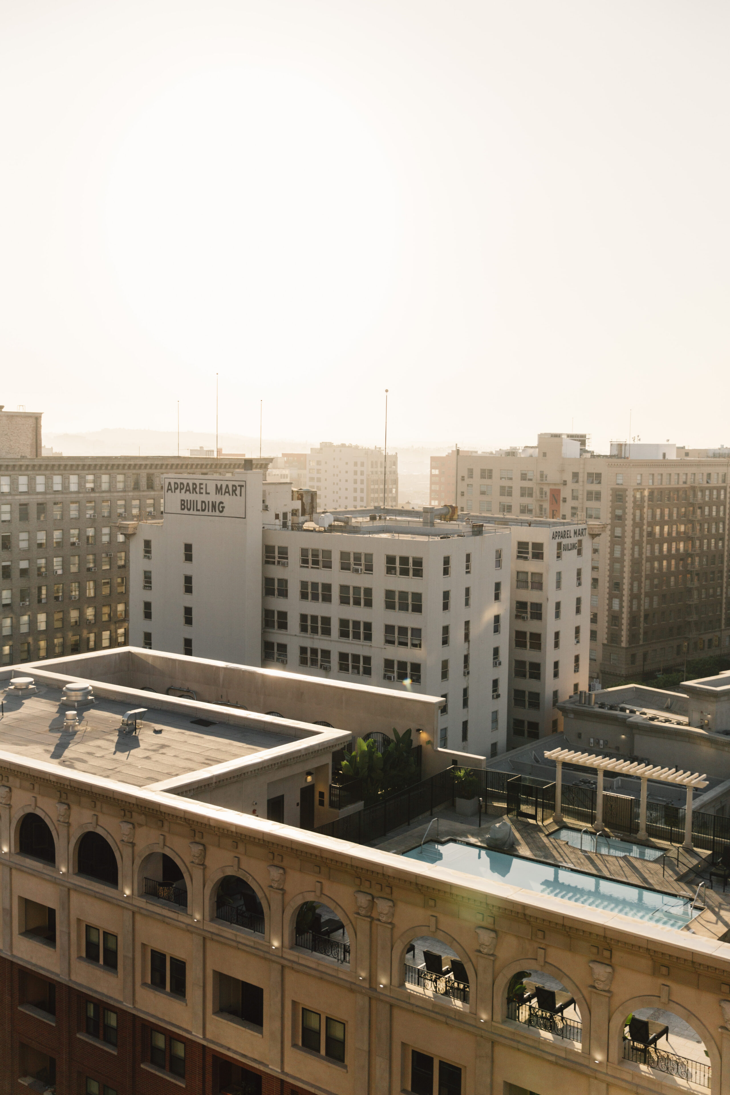 Rooftop cityscape with hazy buildings and soft urban light