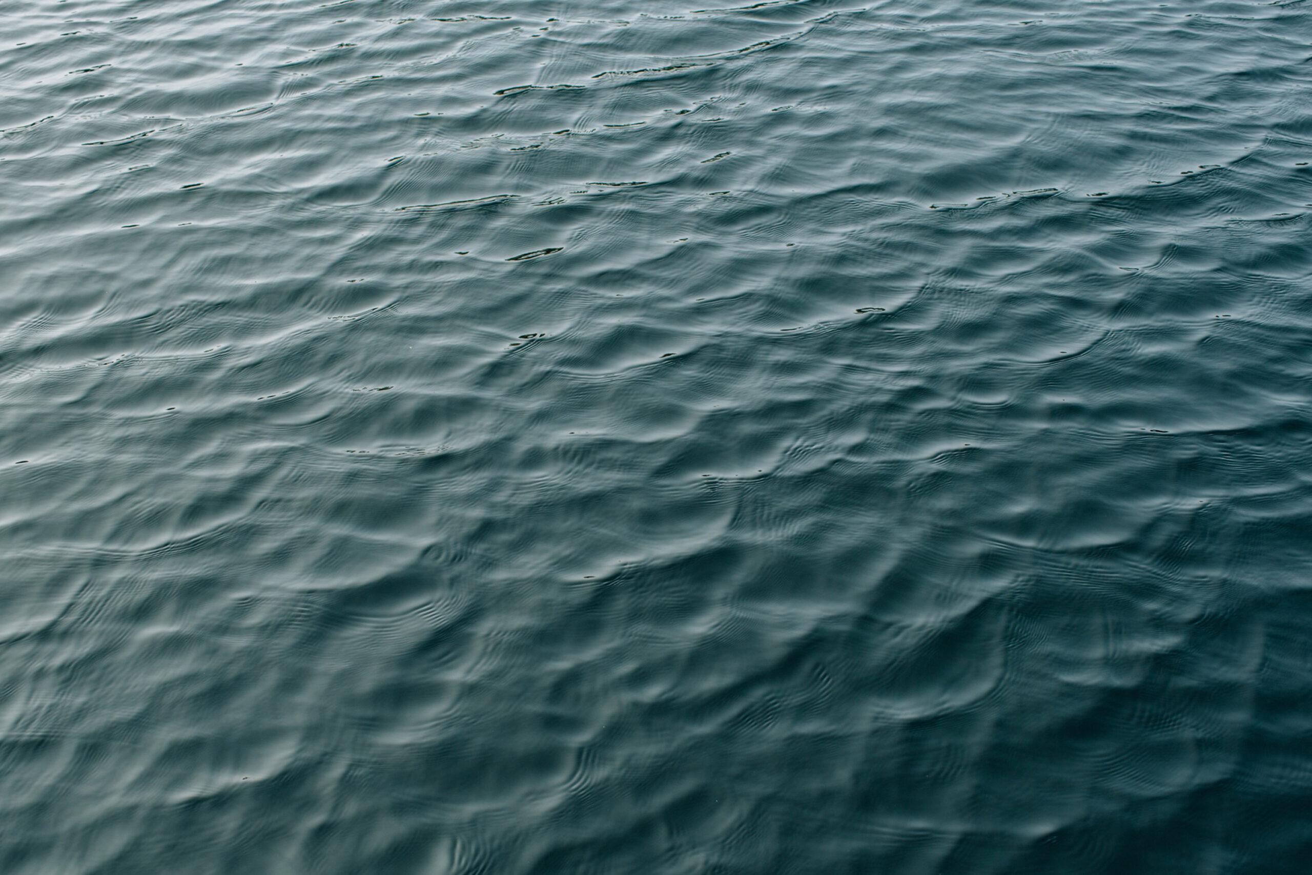 Close-up of rippling blue water surface with natural texture