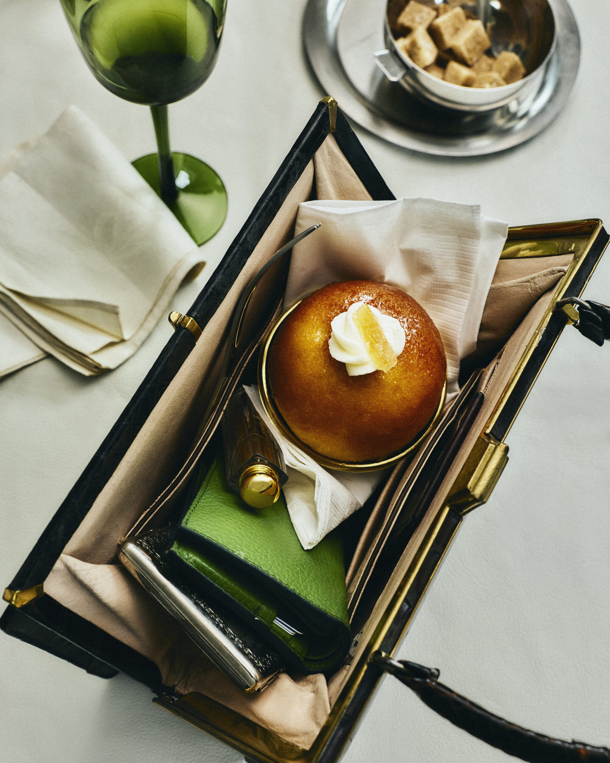 Burger served on a tray with napkin and pickle in a café or dining setting
