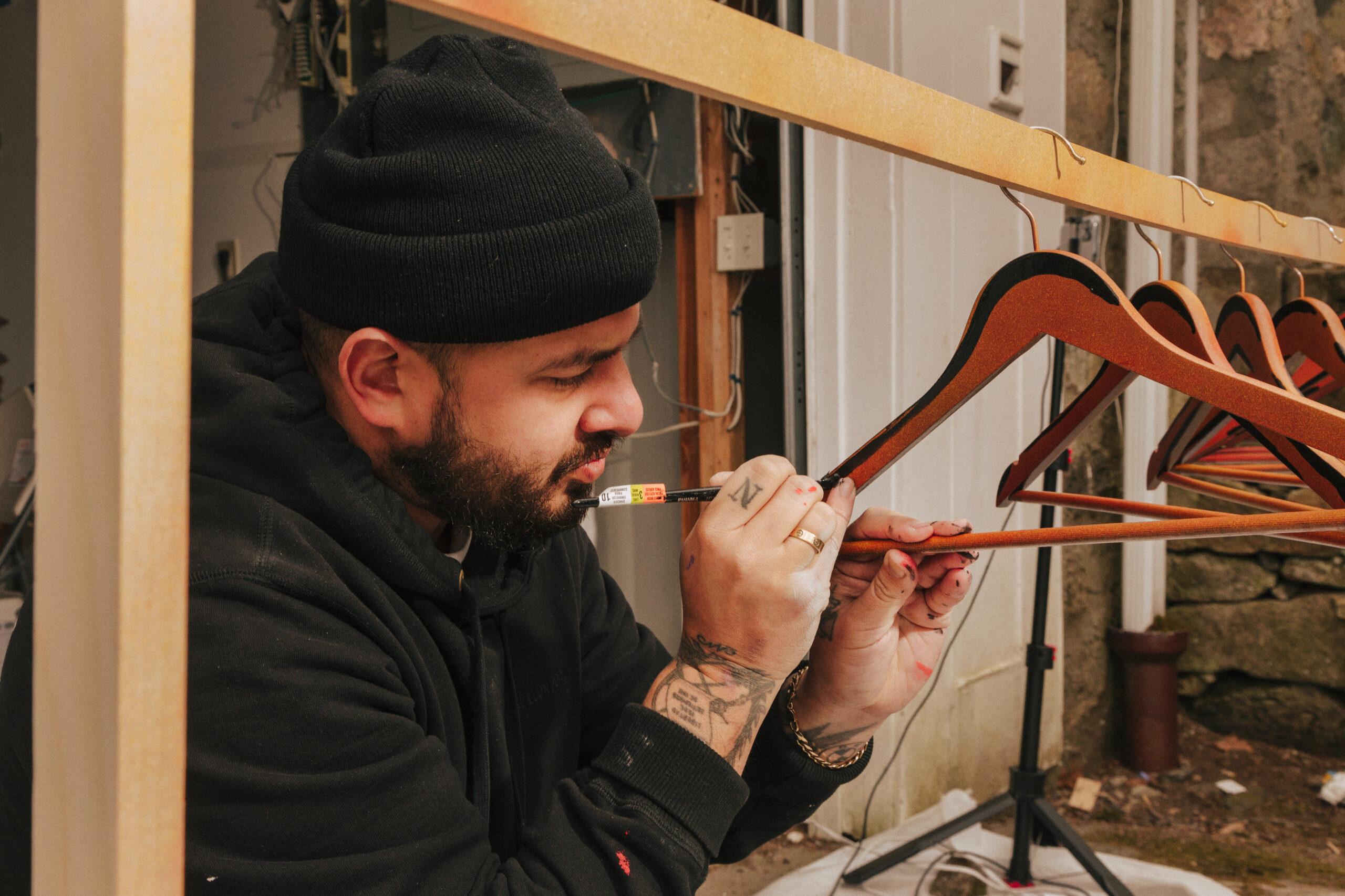 Person working with tools indoors, close-up of hands and equipment